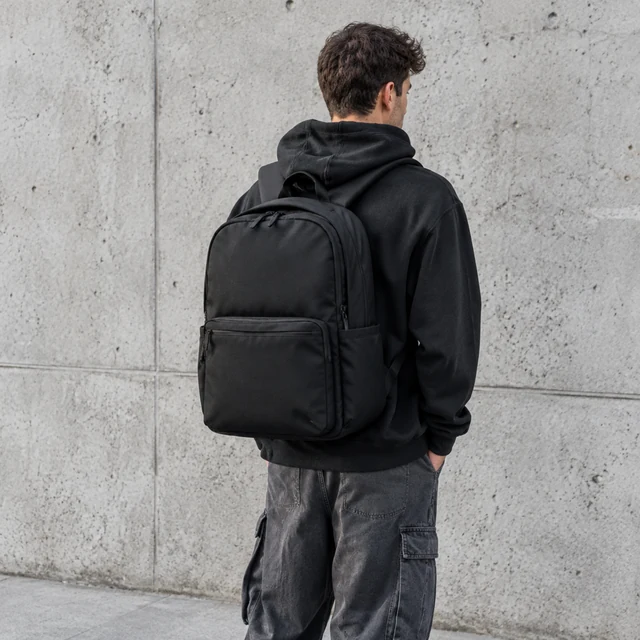 Streetwear look against a concrete wall, editorial framing.